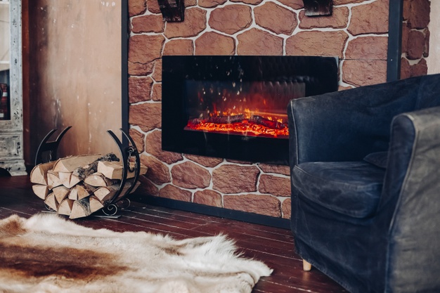 view-fireplace-with-burning-logs-natural-fur-skin-floor-holder-with-logs-cozy-room_132075-6163